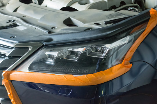 The headlight of the car is glued along the perimeter for polishing the body parts