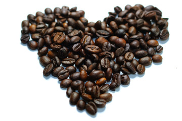 Heart-shaped coffee beans isolated on white