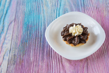 Tasty mini cake on a color gradient background