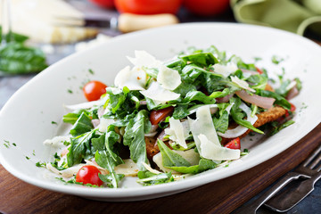 Chicken parmesan topped with arugula