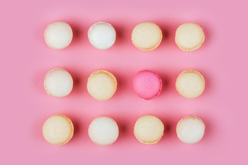 Top view of colorful macaron or macaroon on pink background.
