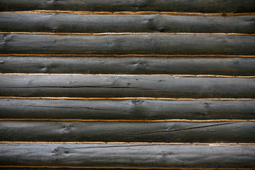 Wooden wall made of timber decorated with ropes