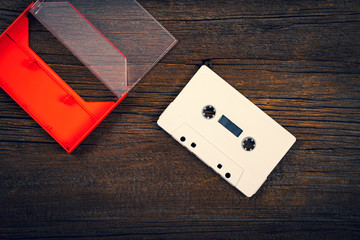 Compact Audio Cassette Tape on Wooden Background with Copy Space