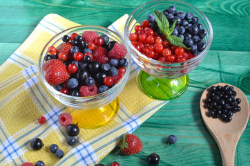 berries of red-blue color on a green background healthy food