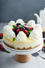 Classic New York cheesecake decorated with whipped cream