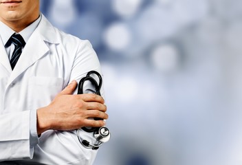 Male doctor with stethoscope on blurred