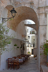 Fototapeta na wymiar Italy, Puglia region, Locorotondo, a whitewashed village in the Itria valley, with its medieval historical center full of stairs, balconies, flowers, arches, frescoed churches, and details