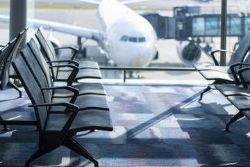 Empty seats in the Airport and the Airplane at background for transportation and travel concept.