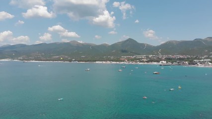 Aerial photography of the sea with boats and mountains