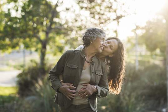 Loving daughter embracing mother at park