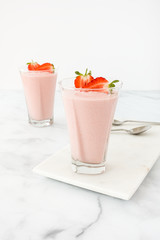Two Glasses filled with Strawberry Mousse on Marble Board