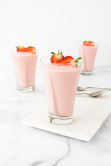 Three Glasses filled with Strawberry Mousse on Marble Board