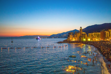 Stella Maris traditional celebration. During the night when thousands of tiny lit candles are left on the water from the boats or from the beach in Camogli, Genoa (Genova) province, Italy. - obrazy, fototapety, plakaty