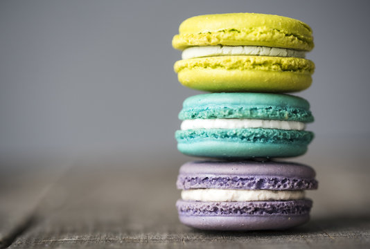 Close-up of colorful macaroons arranged on wooden table