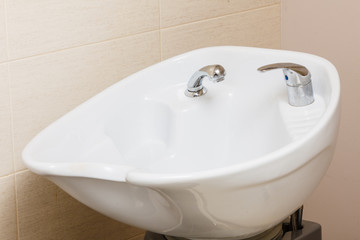 Chair with bowl in hairdresser salon