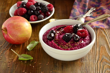 Beetroot smoothies bowl with berries, fruits and seeds