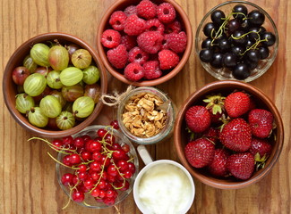 Muesli, berries and various ingredients for healthy breakfast, top view