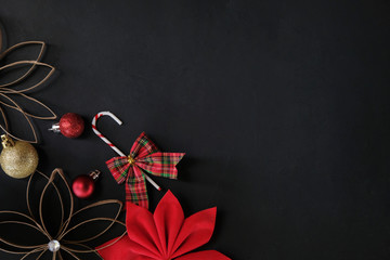Red and black graphic Christmas background with room for text or copy.  Candy cane and ornament on chalkboard