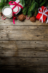 Christmas background with decorations, chocolate cookies and gift boxes on wooden background top view copy space