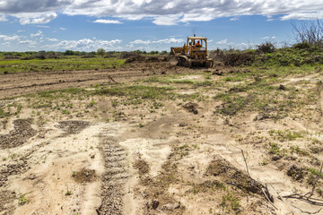 Trucks and heavy machinery clearing the land for the construction of a Solar Energy PV Plant at Choluteca, Honduras