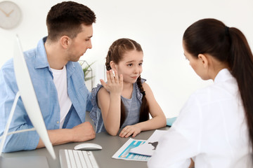 Young man with his daughter having appointment at child psychologist office