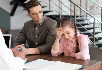 Young man with his daughter having appointment at child psychologist office