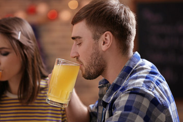 Man drinking beer in sport bar