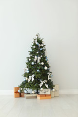 Beautifully decorated Christmas tree and gift boxes, indoors