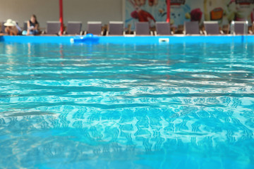 Fototapeta na wymiar Clear refreshing water in swimming pool