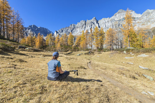 A girl is relaxing near the Nero Lake in the Alpe Veglia and Alpe Devero Natural Park (Buscagna Valley, Alpe Devero, Baceno, Verbano Cusio Ossola province, Piedmont, Italy, Europe)