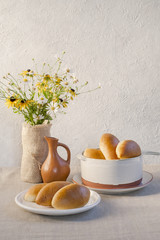 Pirozhki - baked  buns made from yeast dough and glazed with eggs, with cabbage and tomatoes filling, typical for Russia and Ukraine.