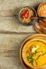 Hokkaido pumpkin soup. Vegetarian food. Wooden bowl with spicy soup on an old wooden table.