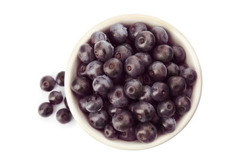 Bowl with fresh acai berries on white background