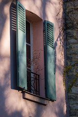 Pink wall and green shutters in Montmartre, Paris