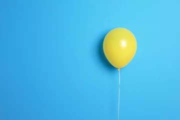 Gardinen Yellow balloon on color background. Celebration time © New Africa