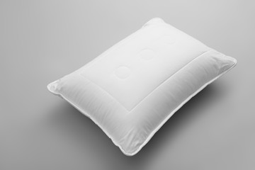 Clean soft bed pillow on grey background