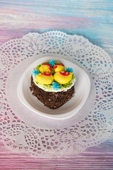 Tasty mini cake on a color gradient background