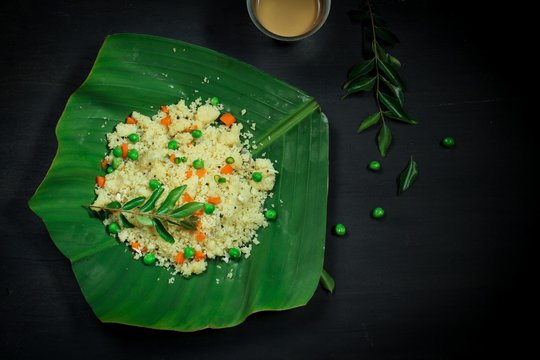 Rava Upma served in banana leaf with tea / South Indian vegan breakfast