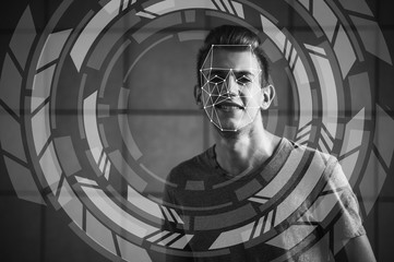 Face recognition. Biometric verification. The concept of a new technology for face recognition on a polygonal mesh. A young guy with a polygonal mesh on his face.