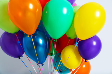 Bunch of colorful balloons on white background, closeup. Festive decor