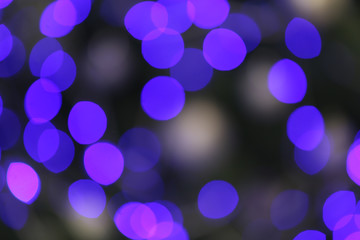 Blurred view of glowing Christmas lights as background. Festive mood