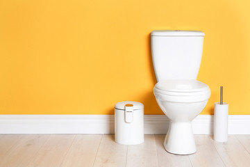 Fototapeta na wymiar New ceramic toilet bowl in modern bathroom with space for text