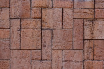 Textured wall tiles under the stone structure. Stone wall use as background.
