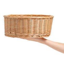 Wicker basket empty in hand on white background isolation