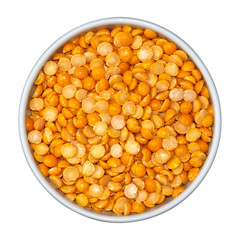 Beans of dry yellow split peas Eidaho in white bowl isolated on white background. Top view.