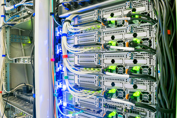 Many wires connect to the network interfaces of powerful Internet servers. Racks with computer...