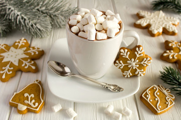 Hot chocolate with marshmallows  and Christmas cookies on the white   wooden background
