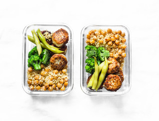 Healthy lunch box - spicy couscous with chickpeas, broccoli, green beans and turkey meatballs on dark background, top view. Copy space