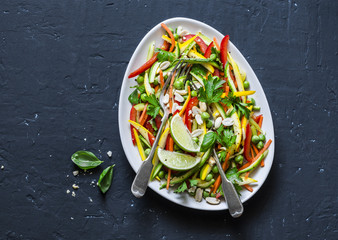 Raw vegetables Pad Thai salad on dark background, top view. Vegetarian healthy food. Copy space