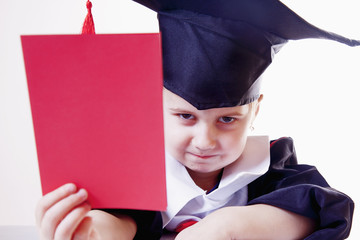 Portrait of serious child girl judge (lawyer) with red card as symbol of disqualification for...